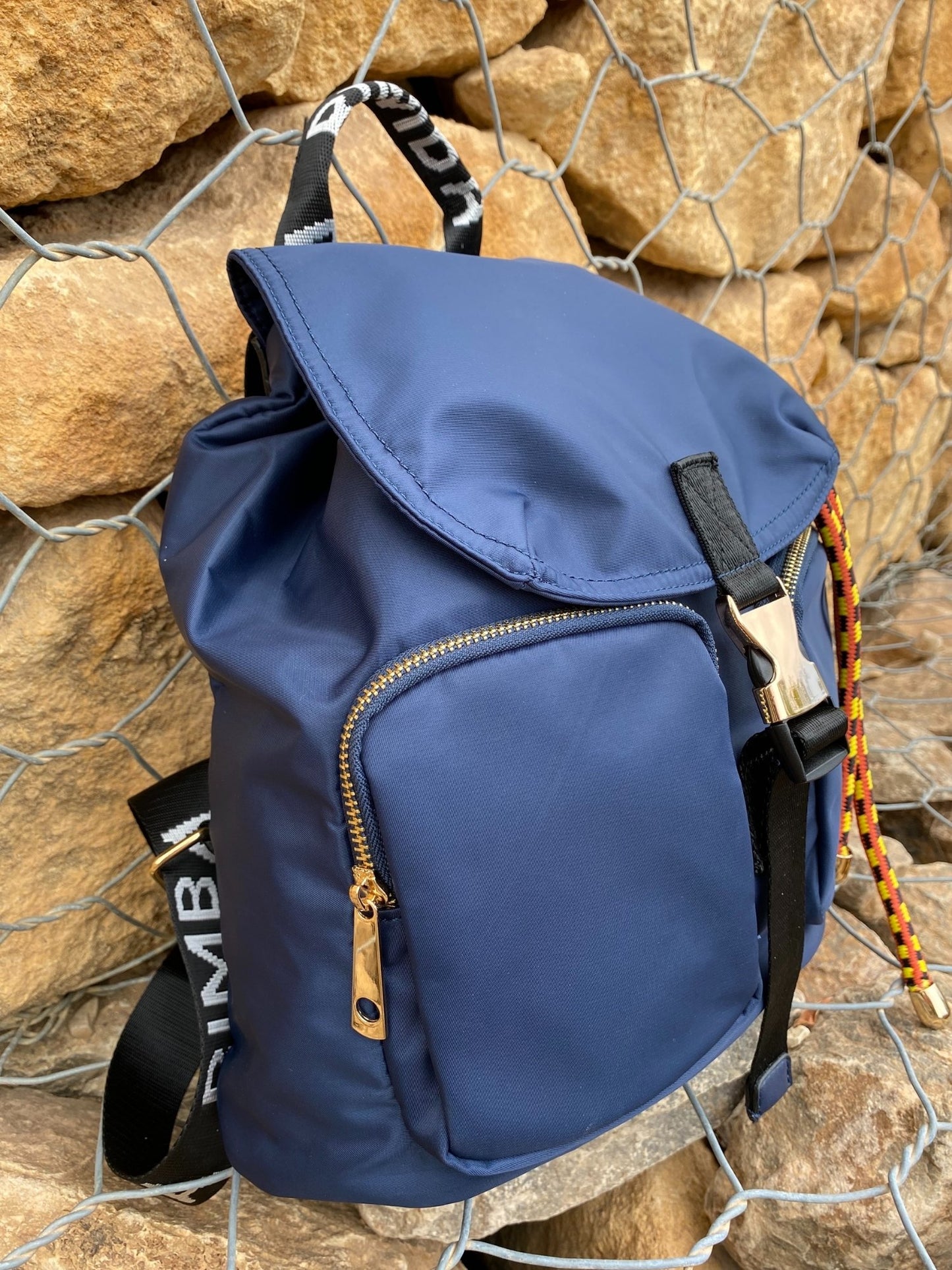 Belted Blue Backpack with Adjustable Straps and Gold Accents