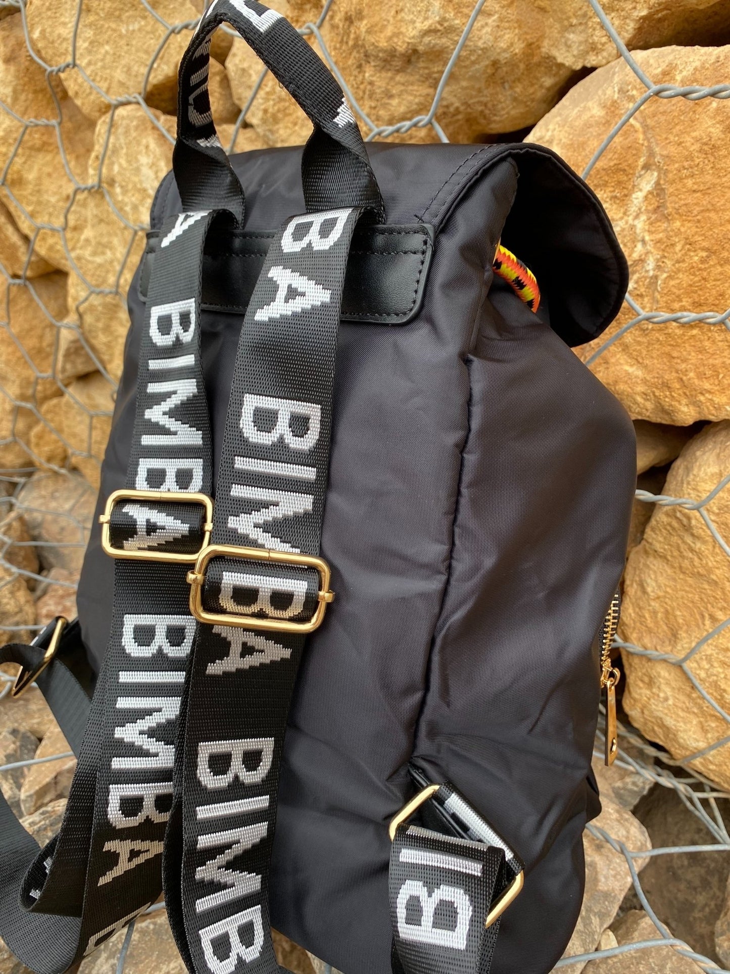 Belted Blue Backpack with Adjustable Straps and Gold Accents