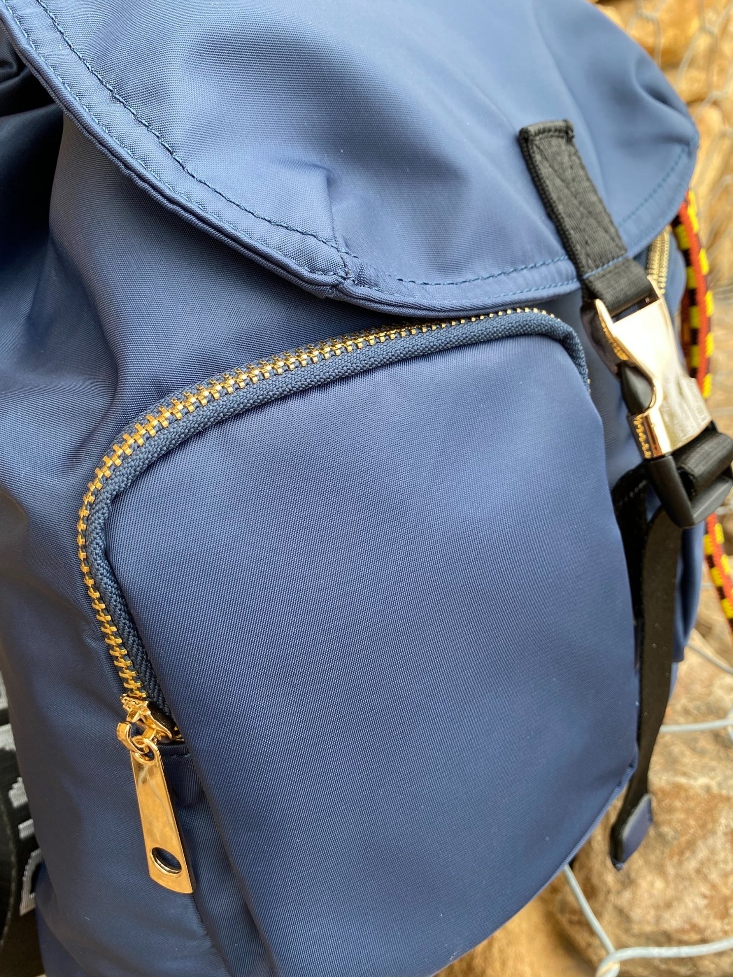 Belted Blue Backpack with Adjustable Straps and Gold Accents