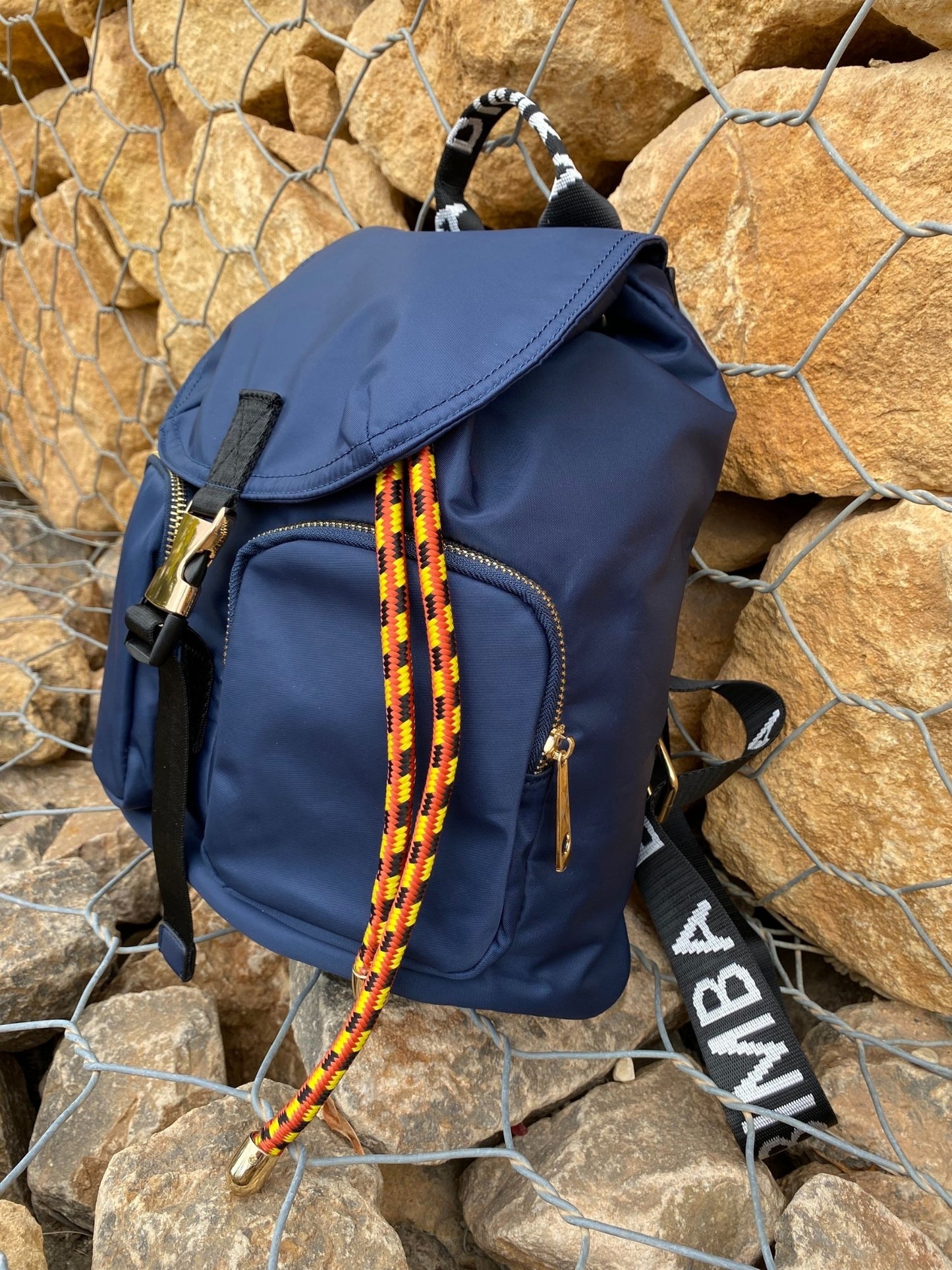 Belted Blue Backpack with Adjustable Straps and Gold Accents