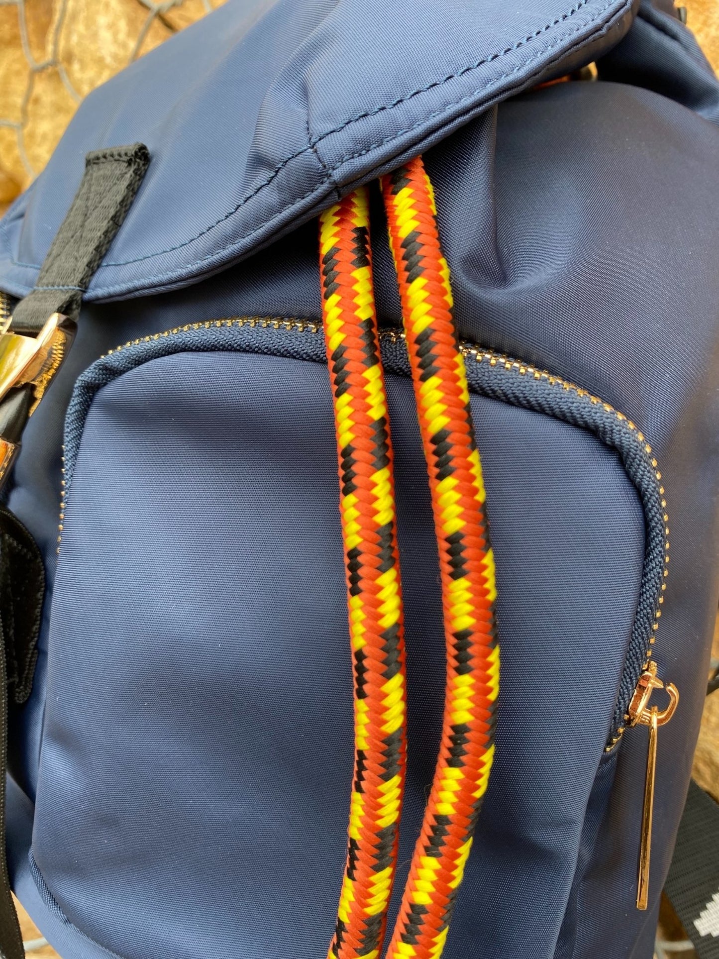 Belted Blue Backpack with Adjustable Straps and Gold Accents