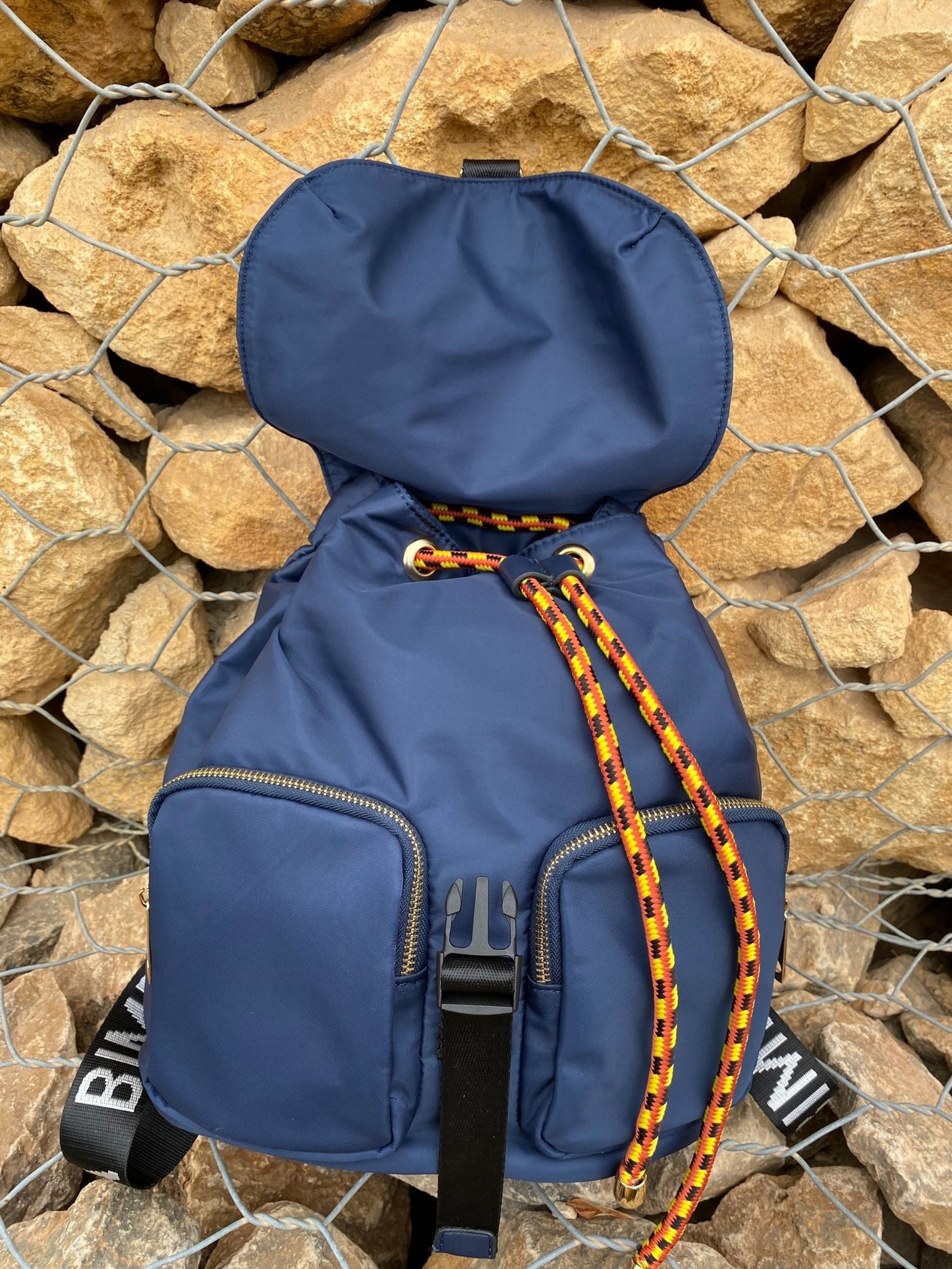 Belted Blue Backpack with Adjustable Straps and Gold Accents