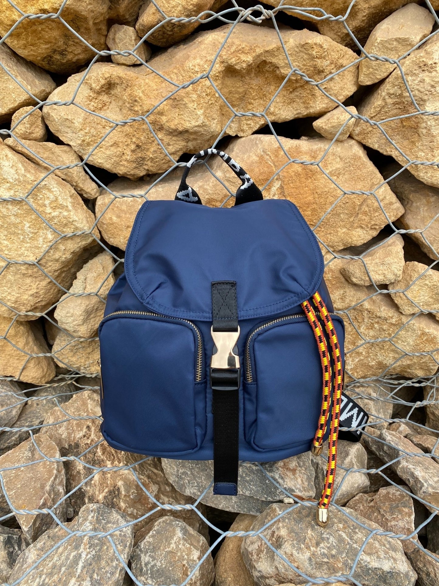 Belted Blue Backpack with Adjustable Straps and Gold Accents