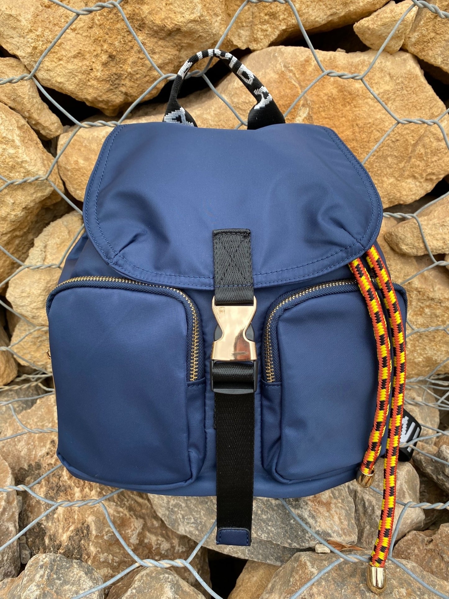 Belted Blue Backpack with Adjustable Straps and Gold Accents