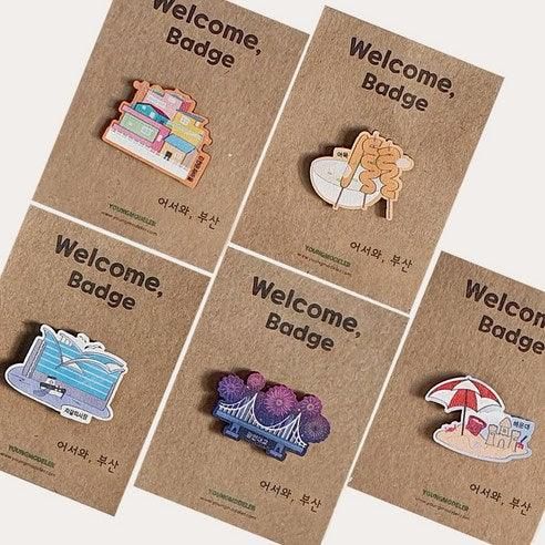 "meta_description": "Discover unique Busan souvenirs with these charming mini wooden badges featuring iconic landmarks.",