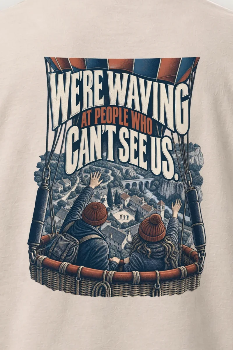 "We’re Waving At People Who Can’t See Us" Heavyweight Unisex Crewneck T-shirt - the graphic up close